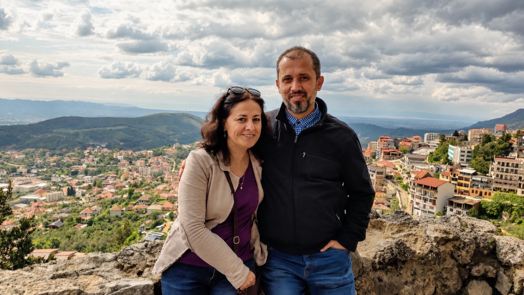 Kejdis and Rudina Bakalli overlooking an Albanian town and surrounding mountains